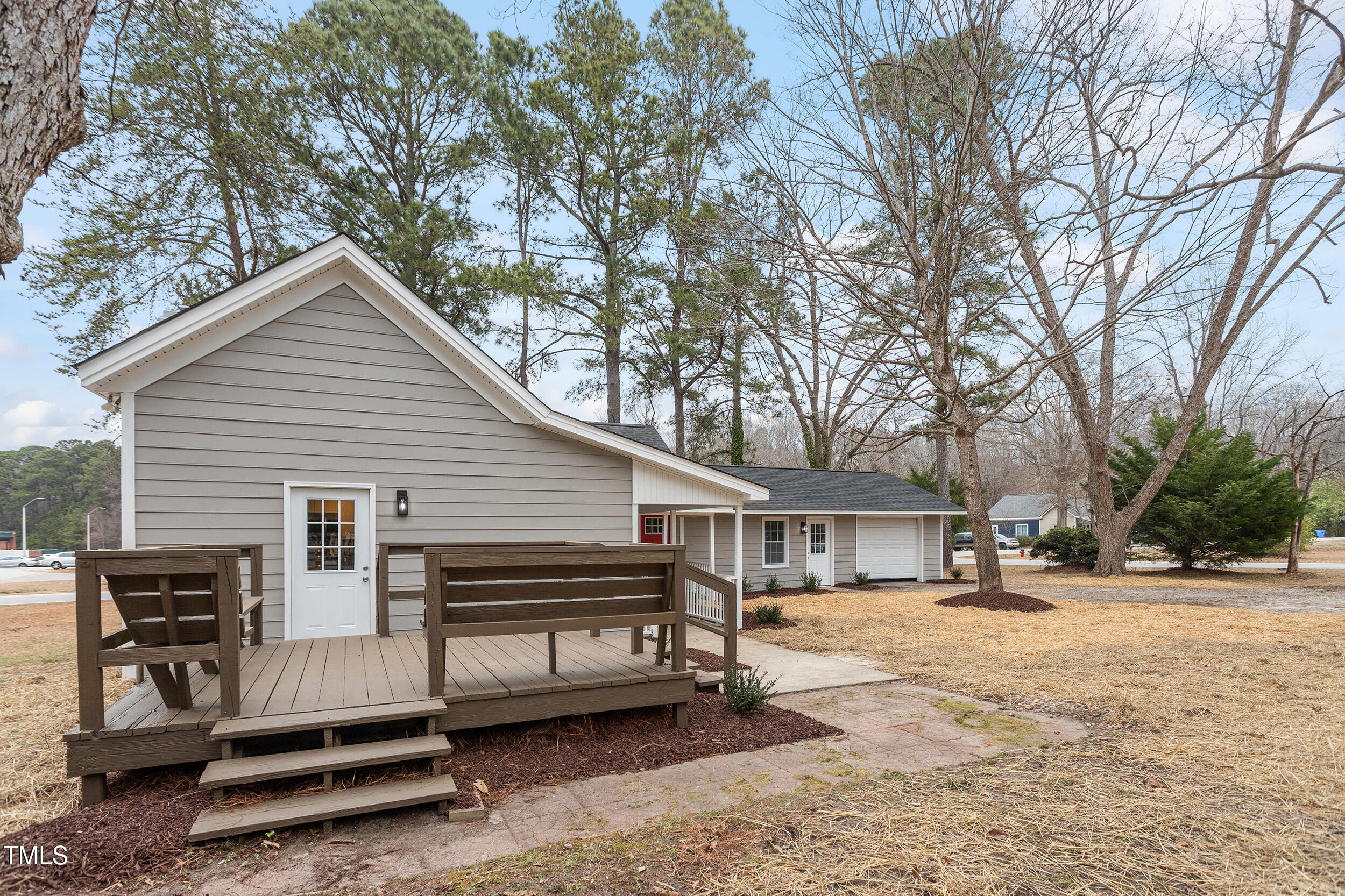 6215 Pine Street Bailey, NC 27807 - Photo 21 of 24 a view of a house with a large tree and wooden fence
