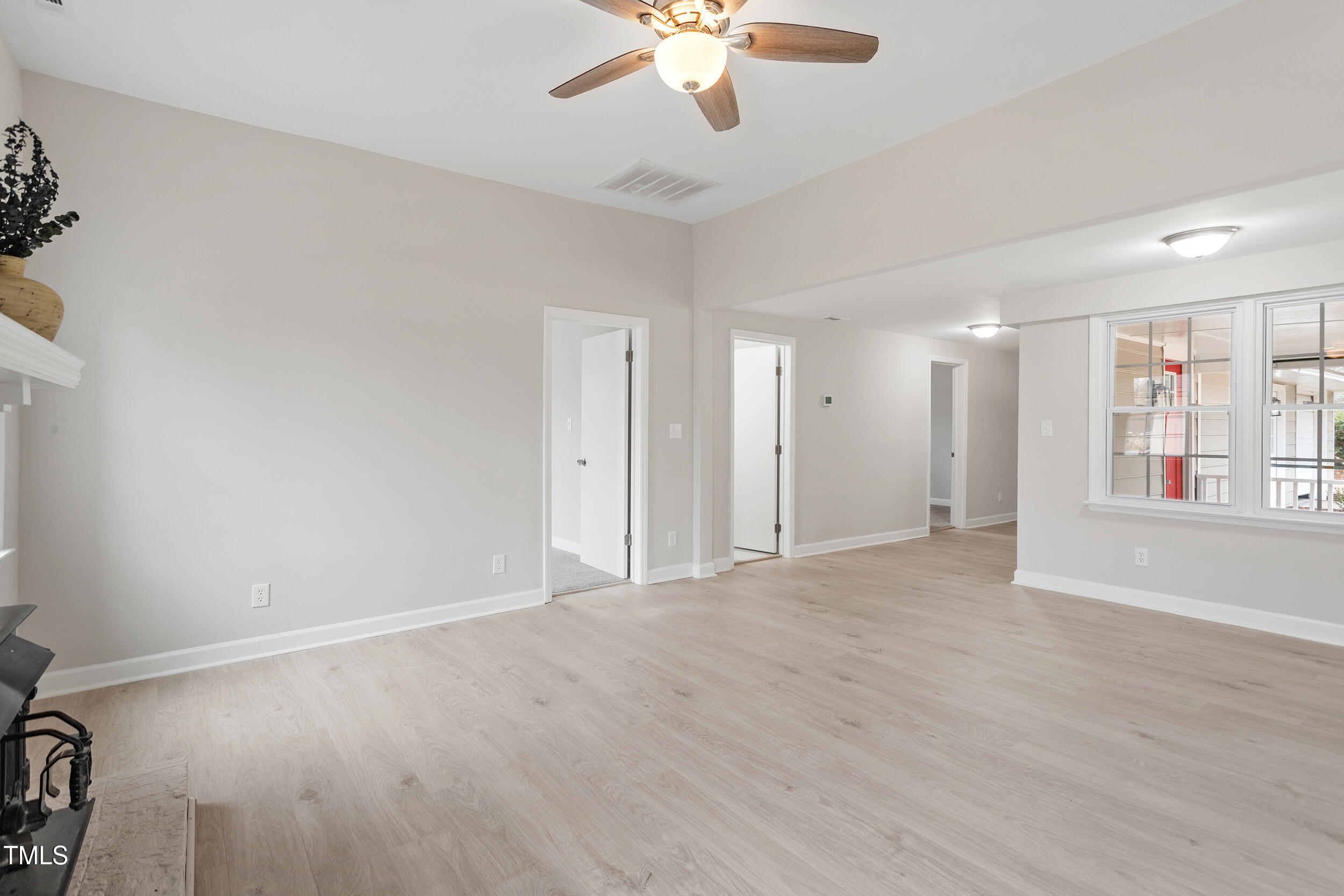6215 Pine Street Bailey, NC 27807 - Photo 4 of 24 a view of an empty room with window and wooden floor