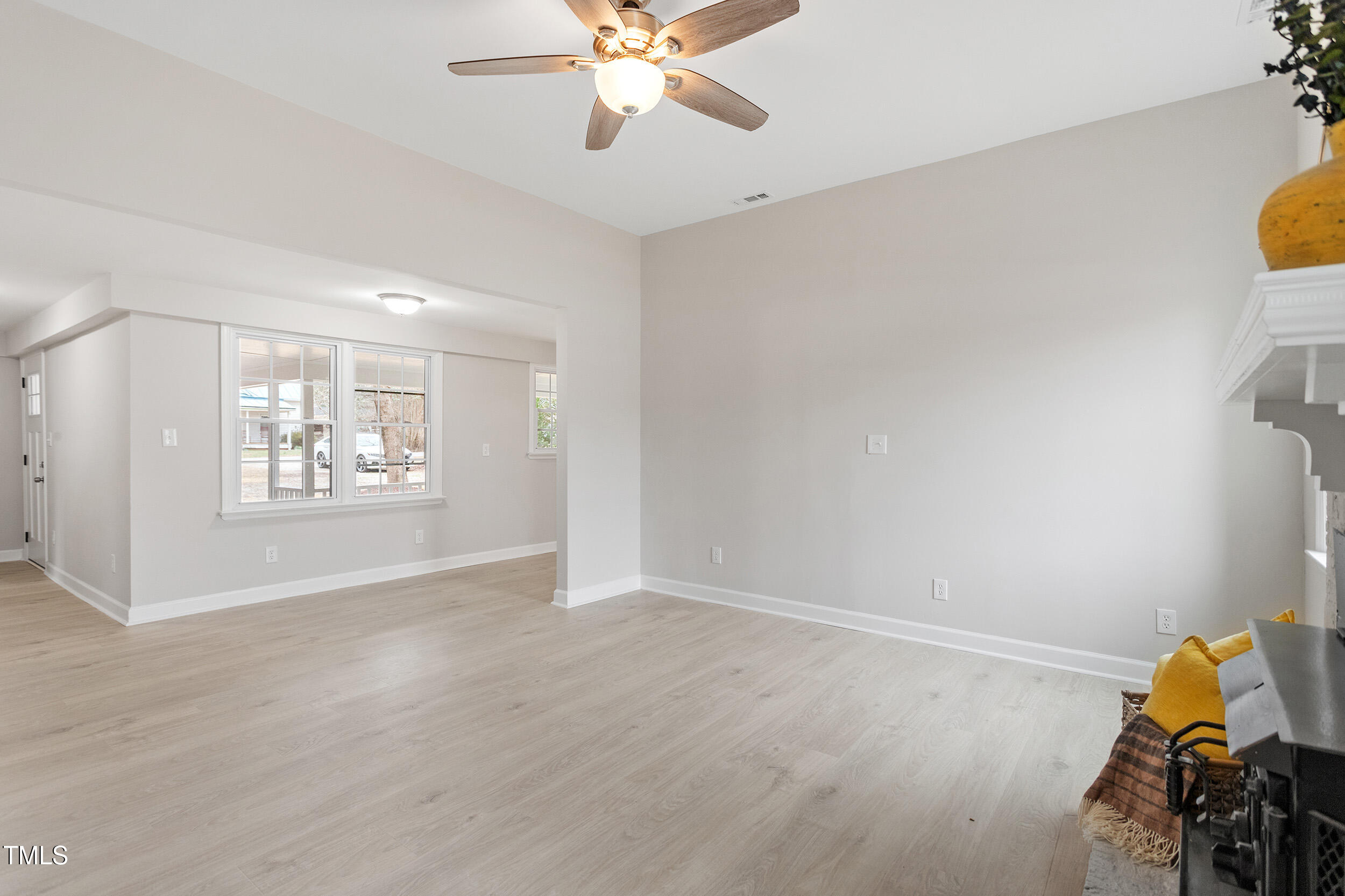 6215 Pine Street Bailey, NC 27807 - Photo 5 of 24 a view of an empty room with window and wooden floor