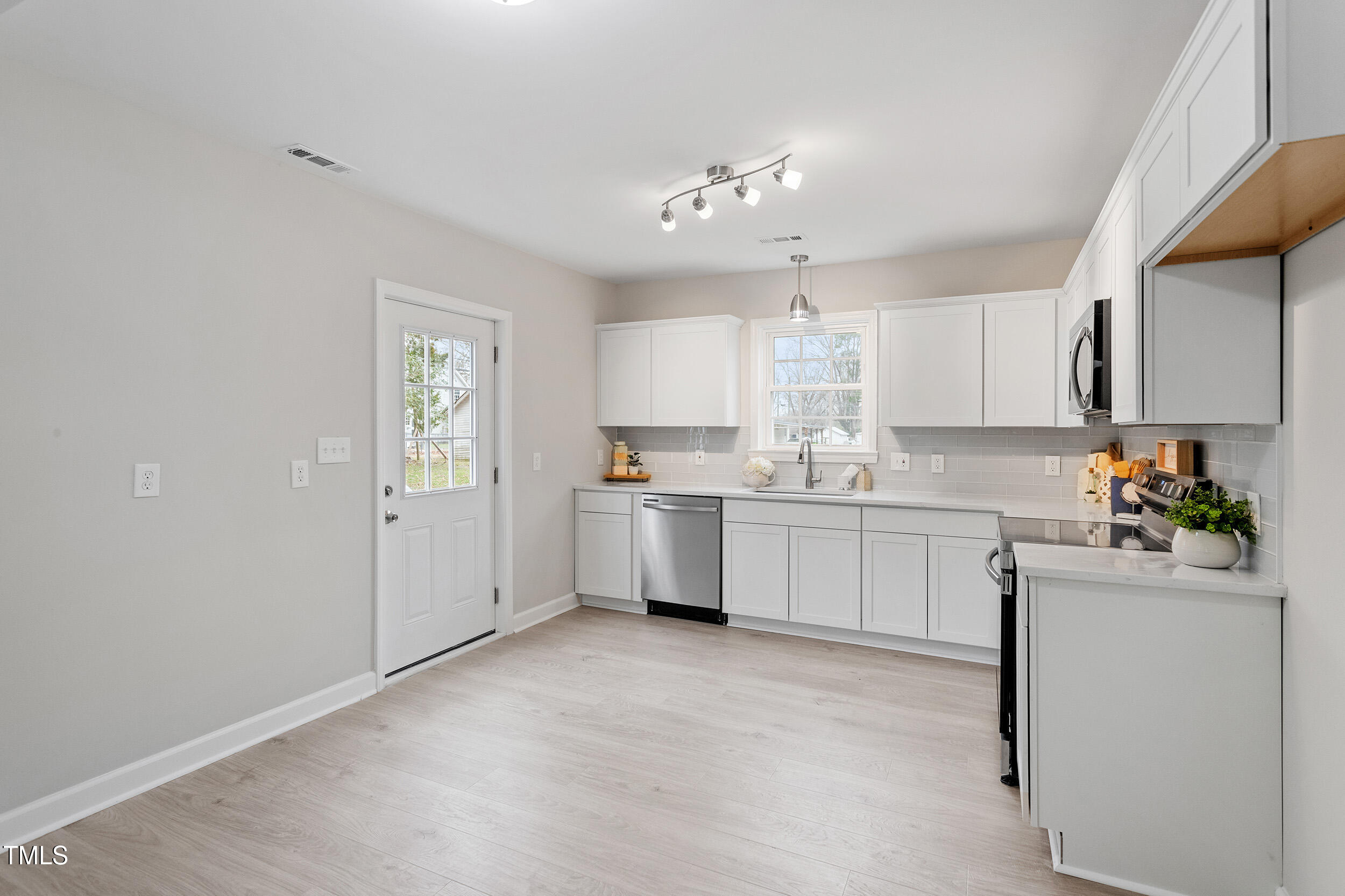 6215 Pine Street Bailey, NC 27807 - Photo 6 of 24 a kitchen with a white cabinets stove and refrigerator