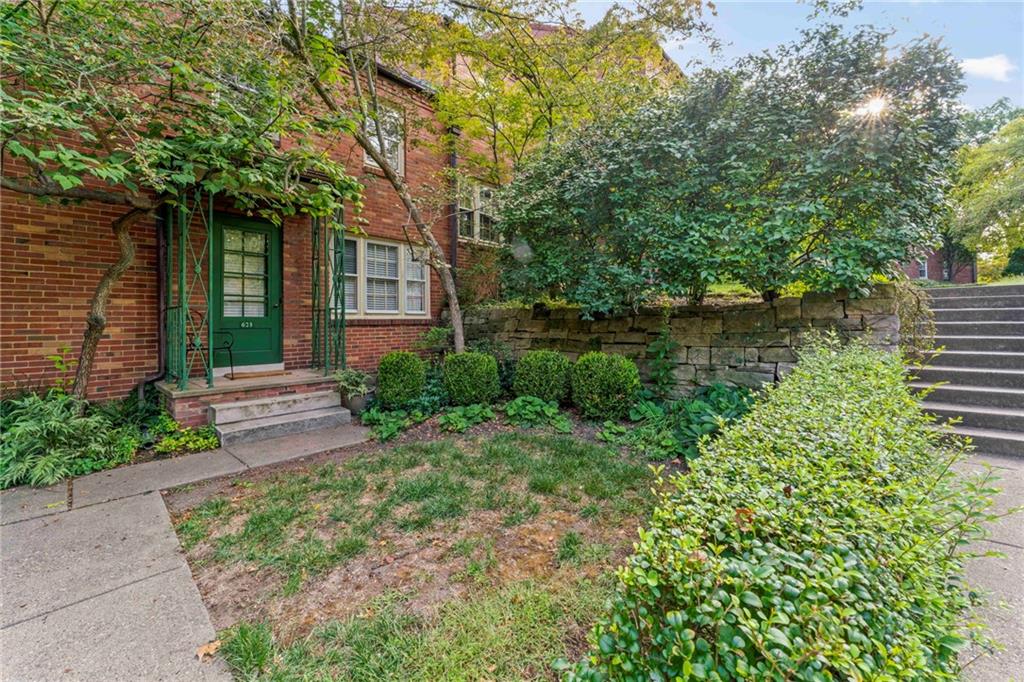 a front view of a house with garden