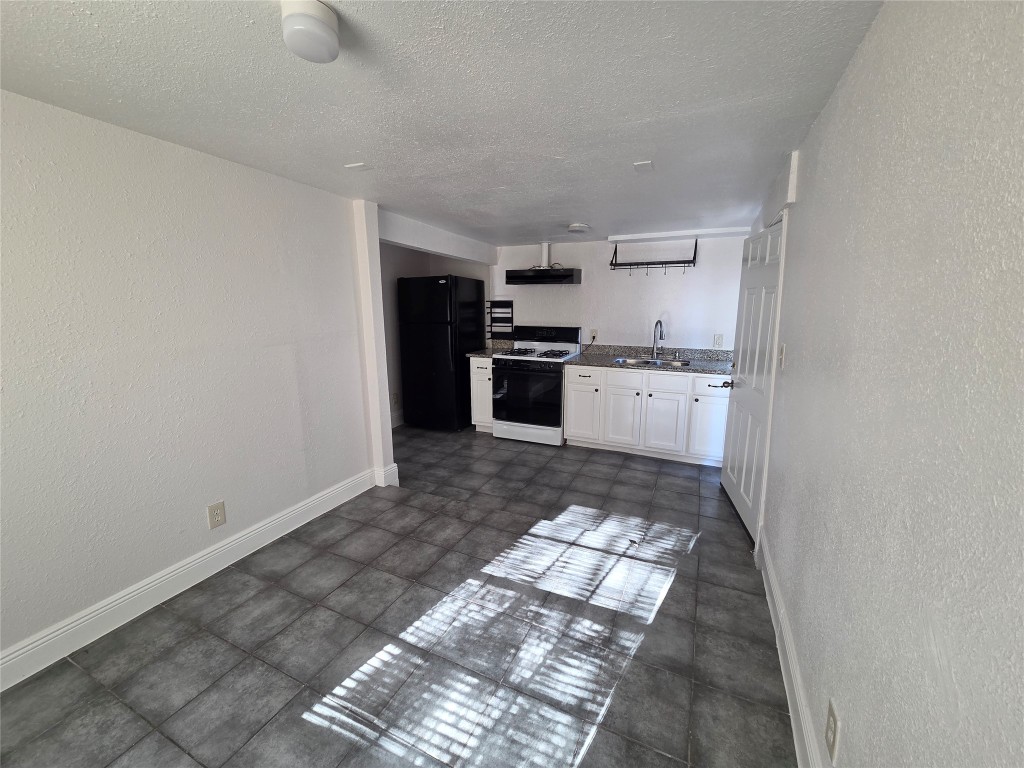 302 71st Street, Unit 3 Houston, TX 77011 - Photo 3 of 8 a large kitchen with cabinets