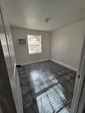 a view of an empty room and a window