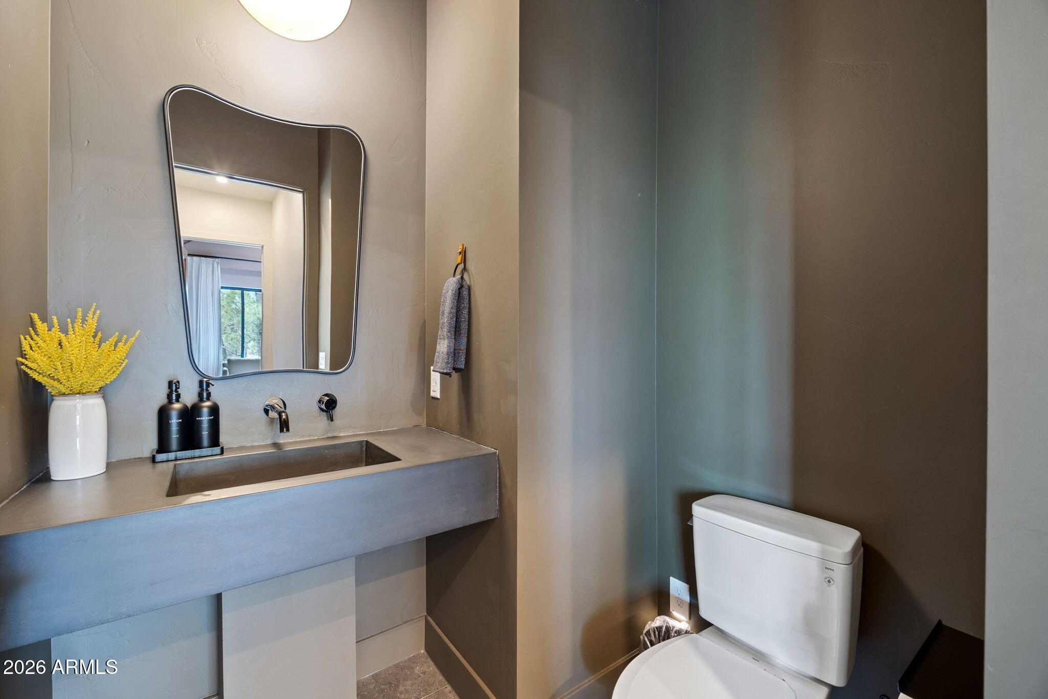 2441 South Monkshood Road Show Low, AZ 85901 - Photo 27 of 90 a bathroom with a toilet sink and mirror