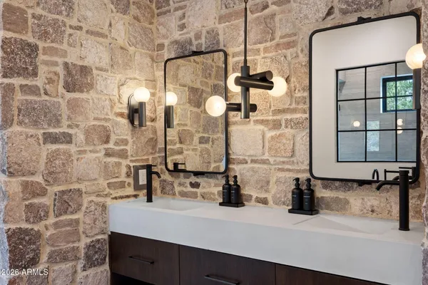a bathroom with a double vanity sink toilet and shower