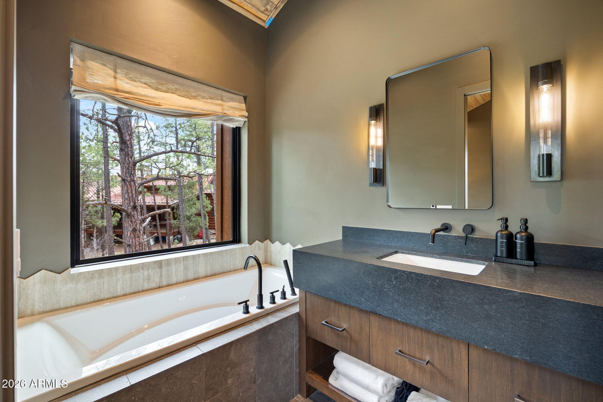 2441 South Monkshood Road Show Low, AZ 85901 - Photo 39 of 90 a bathroom with a granite countertop sink and a large mirror