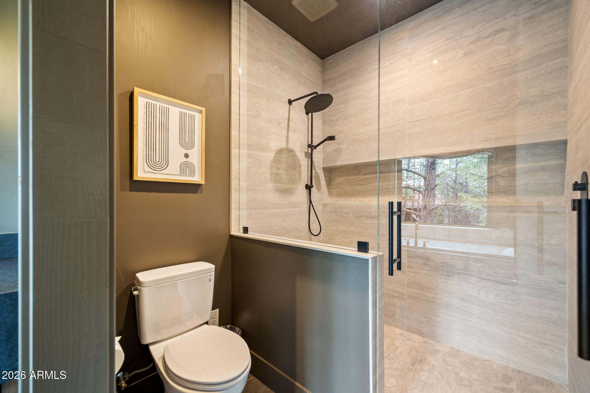 2441 South Monkshood Road Show Low, AZ 85901 - Photo 40 of 90 a bathroom with a toilet a sink and shower