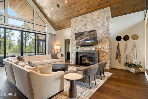 a living room with fireplace furniture and a wooden floor