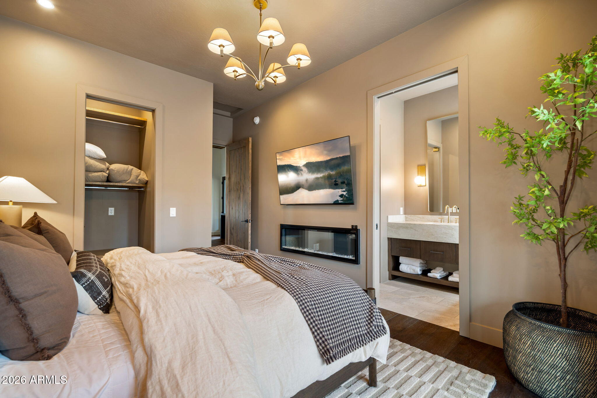 2441 South Monkshood Road Show Low, AZ 85901 - Photo 50 of 90 a spacious bedroom with a bed and a chandelier