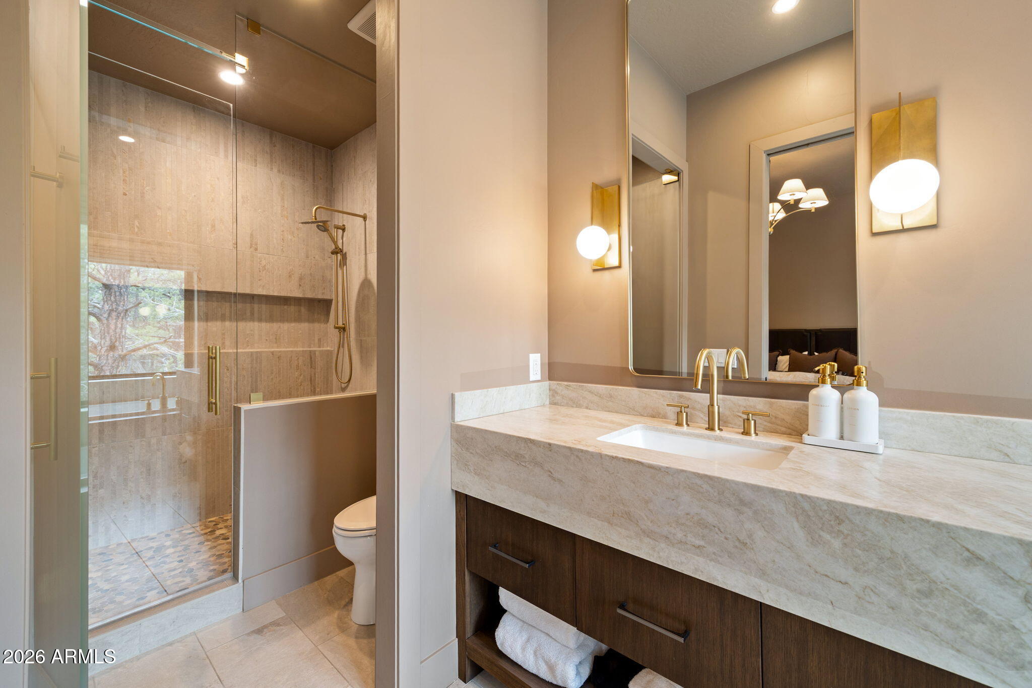 2441 South Monkshood Road Show Low, AZ 85901 - Photo 51 of 90 a bathroom with a double vanity sink toilet and shower