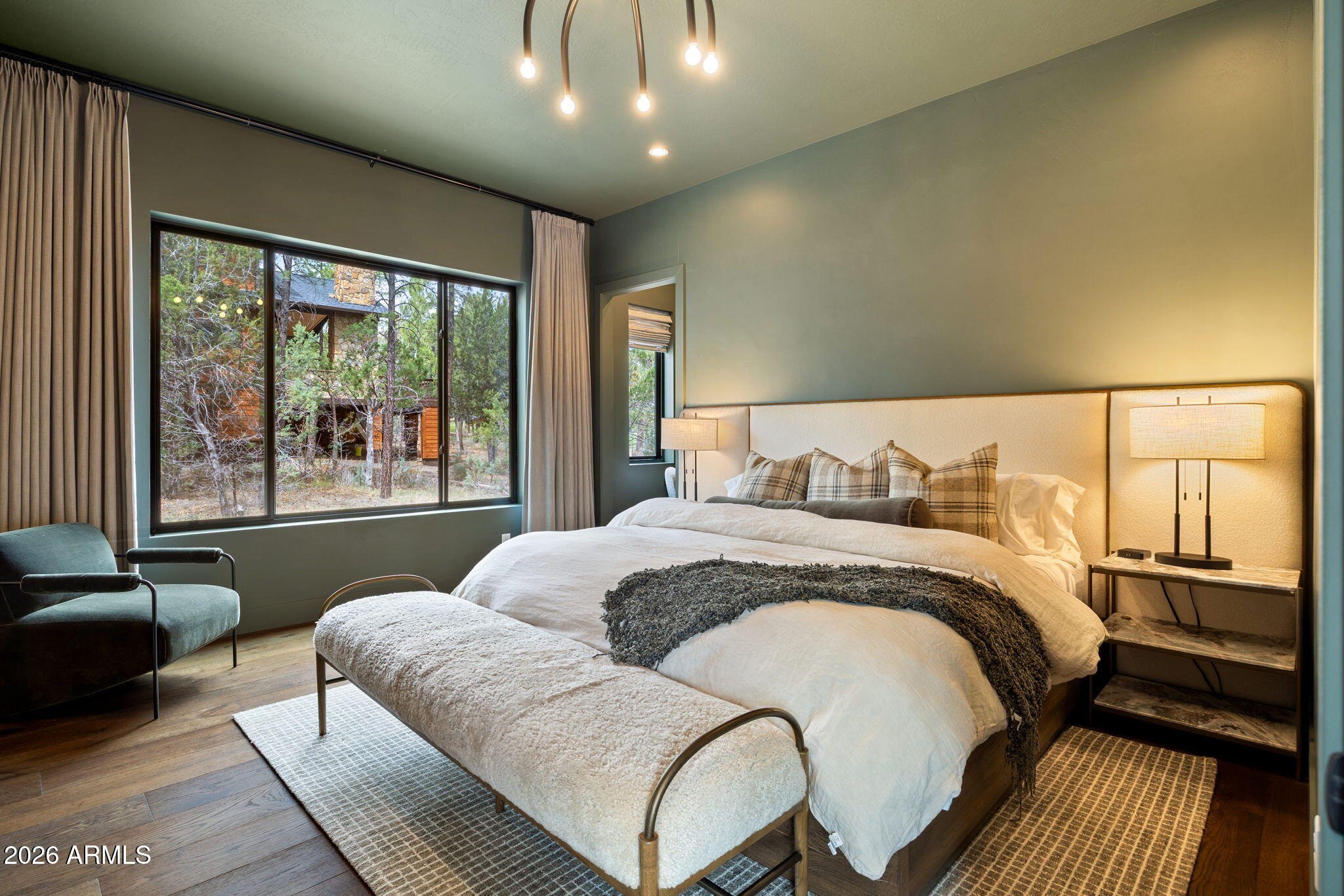 2441 South Monkshood Road Show Low, AZ 85901 - Photo 54 of 90 a bedroom with a large bed and a large window