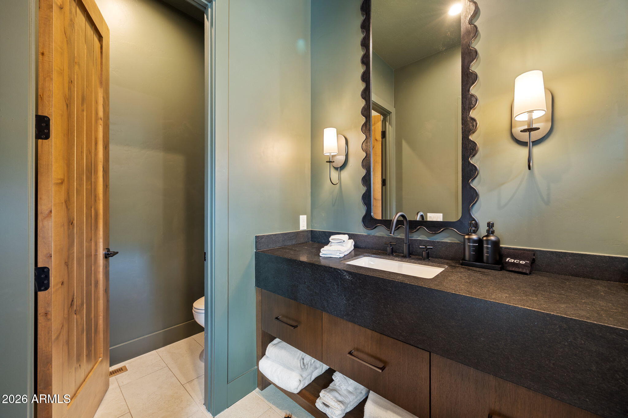 2441 South Monkshood Road Show Low, AZ 85901 - Photo 57 of 90 a bathroom with a sink and a mirror
