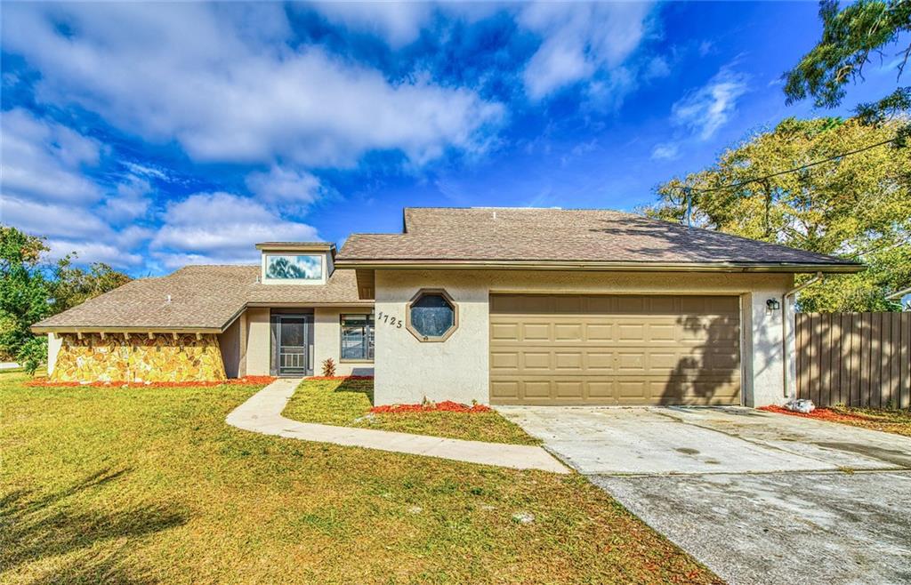 1725 Larkin Road Spring Hill, FL 34608 - Photo 1 of 1 a front view of a house with a yard