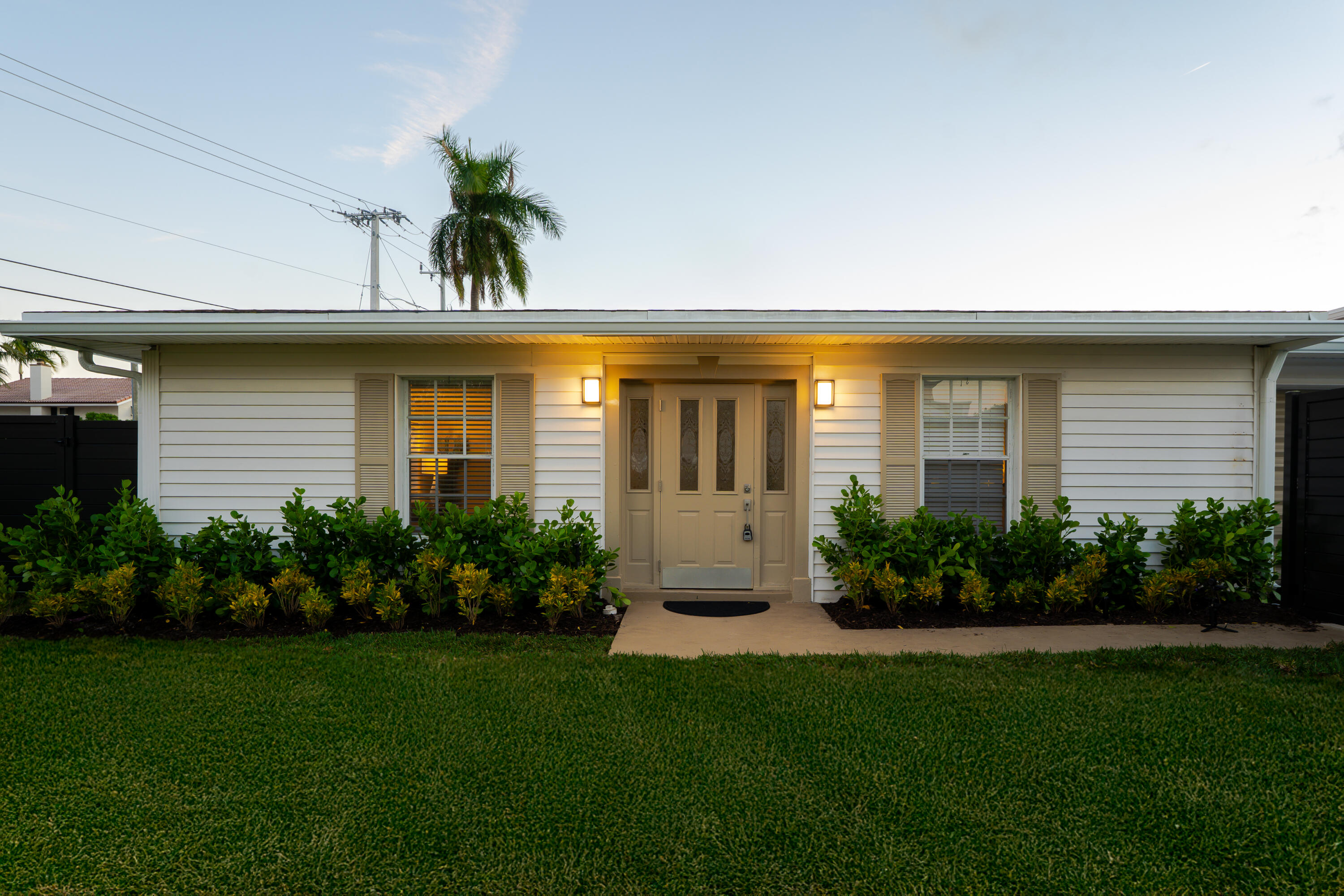 3199 Northeast 6th Drive Boca Raton, FL 33431 - Photo 6 of 49 a front view of a house with a garden
