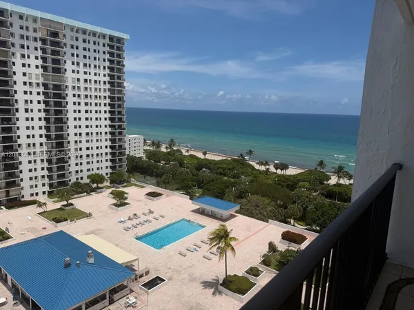 a view of a balcony with an outdoor seating