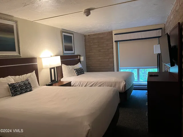 a bedroom with a bed and a television