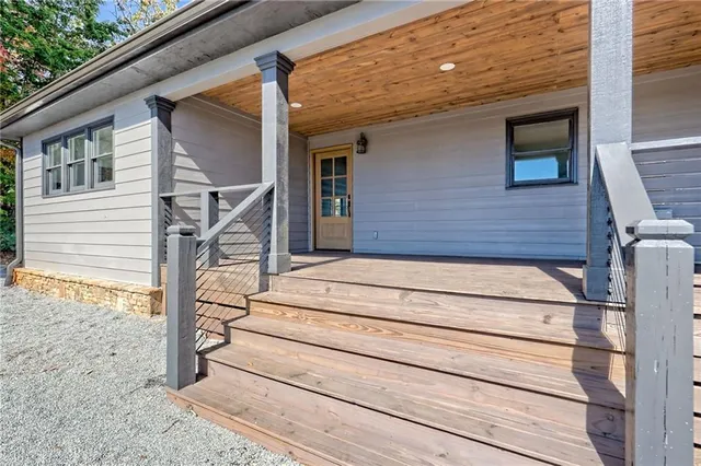 a view of a room with wooden floor and a window