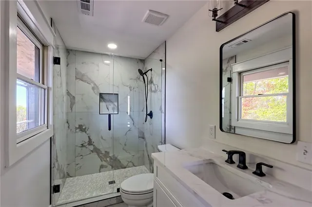 an empty room with a window and a ceiling fan