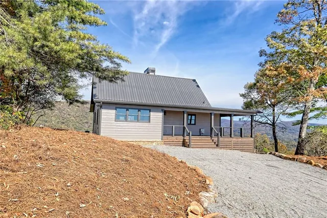 a view of an empty room with window and fire place