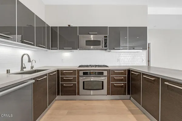 a kitchen with cabinets appliances and a sink