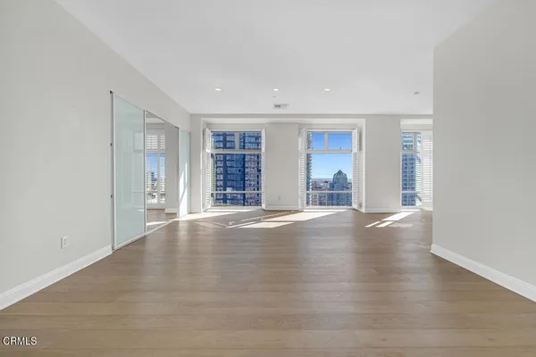 a view of a room with wooden floor and a window