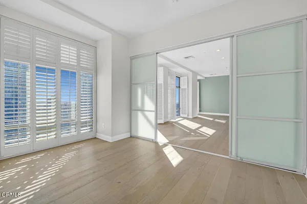 a spacious bathroom with a granite countertop sink a toilet a mirror and shower