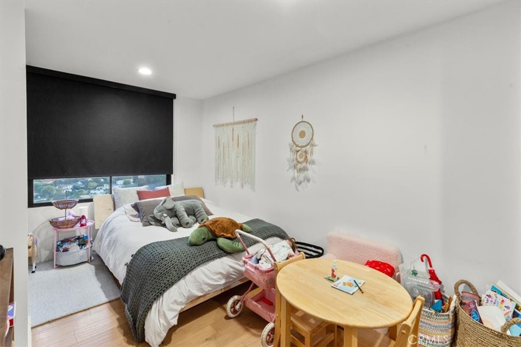 10501 Wilshire Boulevard, Unit 2212 Los Angeles, CA 90024 - Photo 11 of 25 a bedroom with a bed and a flat screen tv