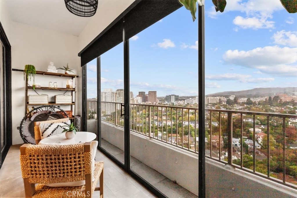 10501 Wilshire Boulevard, Unit 2212 Los Angeles, CA 90024 - Photo 16 of 25 a bedroom with furniture and a floor to ceiling window