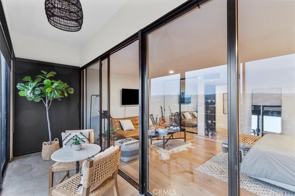 10501 Wilshire Boulevard, Unit 2212 Los Angeles, CA 90024 - Photo 17 of 25 a living room with furniture and a potted plant