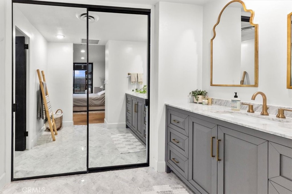 10501 Wilshire Boulevard, Unit 2212 Los Angeles, CA 90024 - Photo 19 of 25 a spacious bathroom with a granite countertop sink mirror and refrigerator