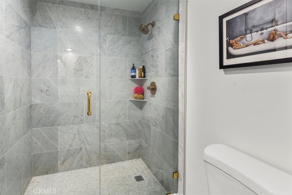 10501 Wilshire Boulevard, Unit 2212 Los Angeles, CA 90024 - Photo 20 of 25 a bathroom with a shower and a toilet