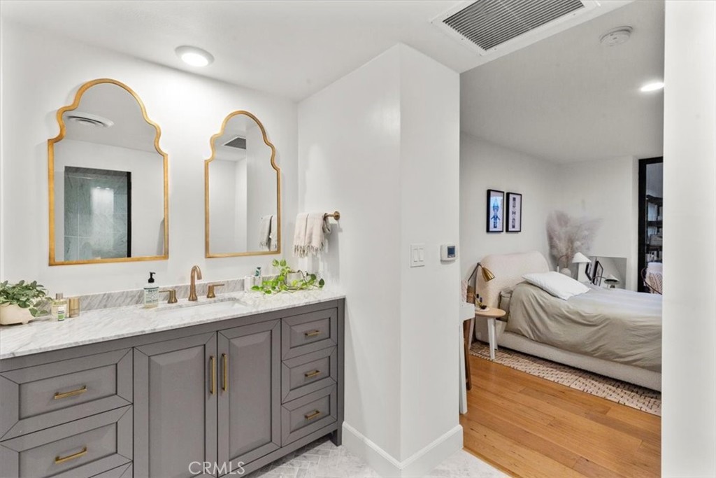 10501 Wilshire Boulevard, Unit 2212 Los Angeles, CA 90024 - Photo 21 of 25 a en suite bathroom with double sink and a mirror