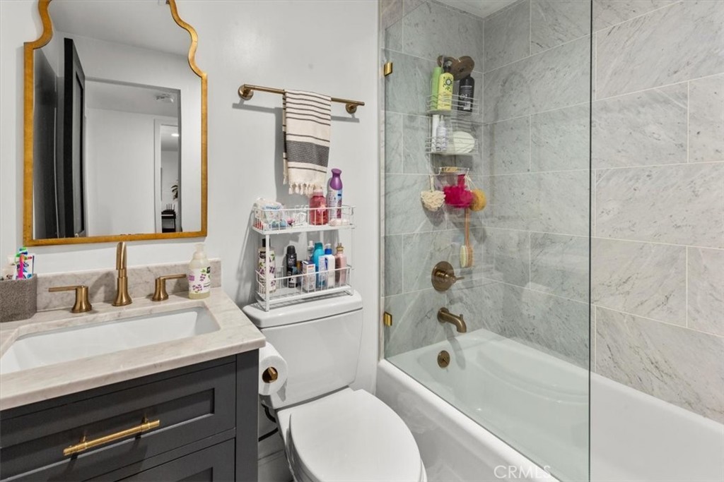10501 Wilshire Boulevard, Unit 2212 Los Angeles, CA 90024 - Photo 22 of 25 a bathroom with a bathtub shower sink vanity and toilet