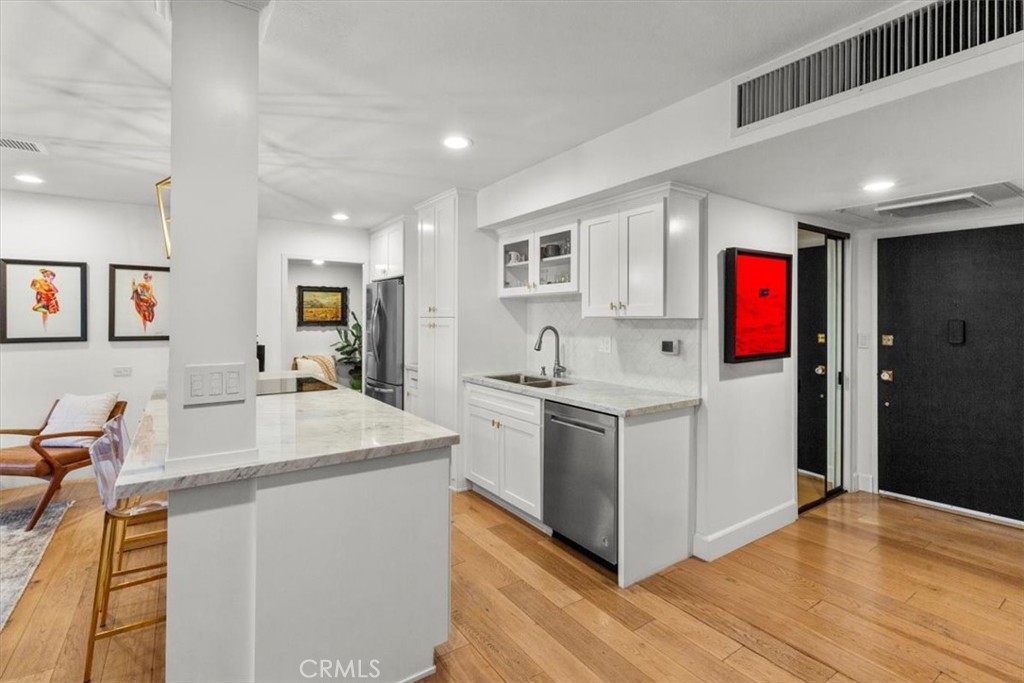 10501 Wilshire Boulevard, Unit 2212 Los Angeles, CA 90024 - Photo 5 of 25 a kitchen with stainless steel appliances kitchen island granite countertop a sink and a refrigerator