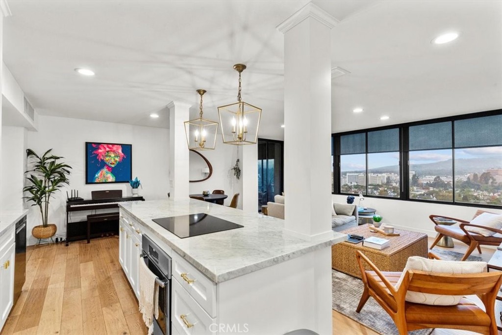10501 Wilshire Boulevard, Unit 2212 Los Angeles, CA 90024 - Photo 9 of 25 a kitchen with stainless steel appliances kitchen island granite countertop a sink and a stove