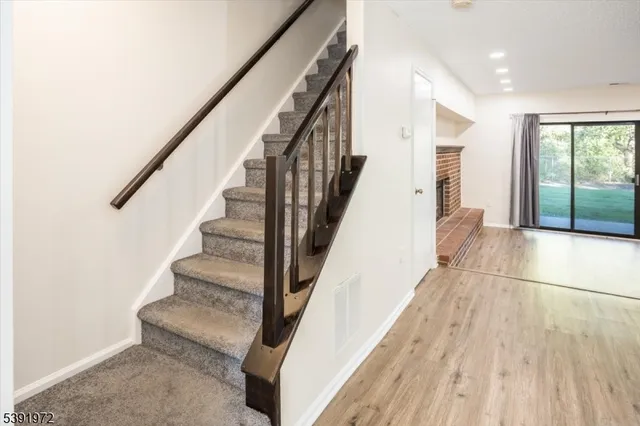 a view of entryway with wooden floor and stairs