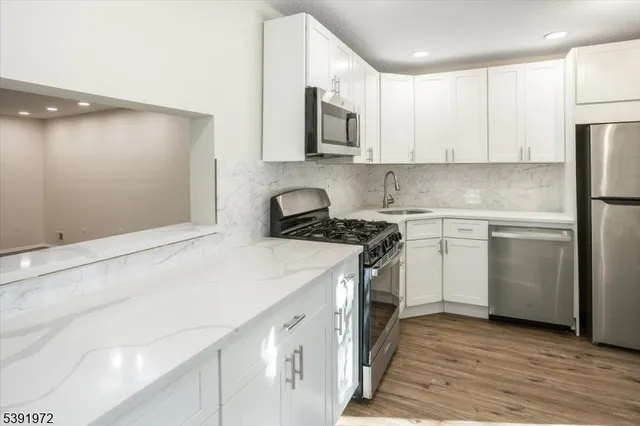 a kitchen with a sink stove and refrigerator