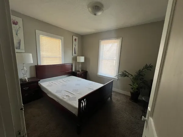 a living room with a table chairs and a window