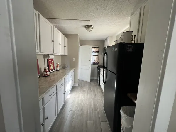 a kitchen with stainless steel appliances granite countertop a refrigerator and a stove