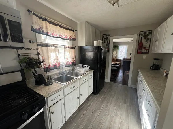 a kitchen with stainless steel appliances a refrigerator and a stove top oven