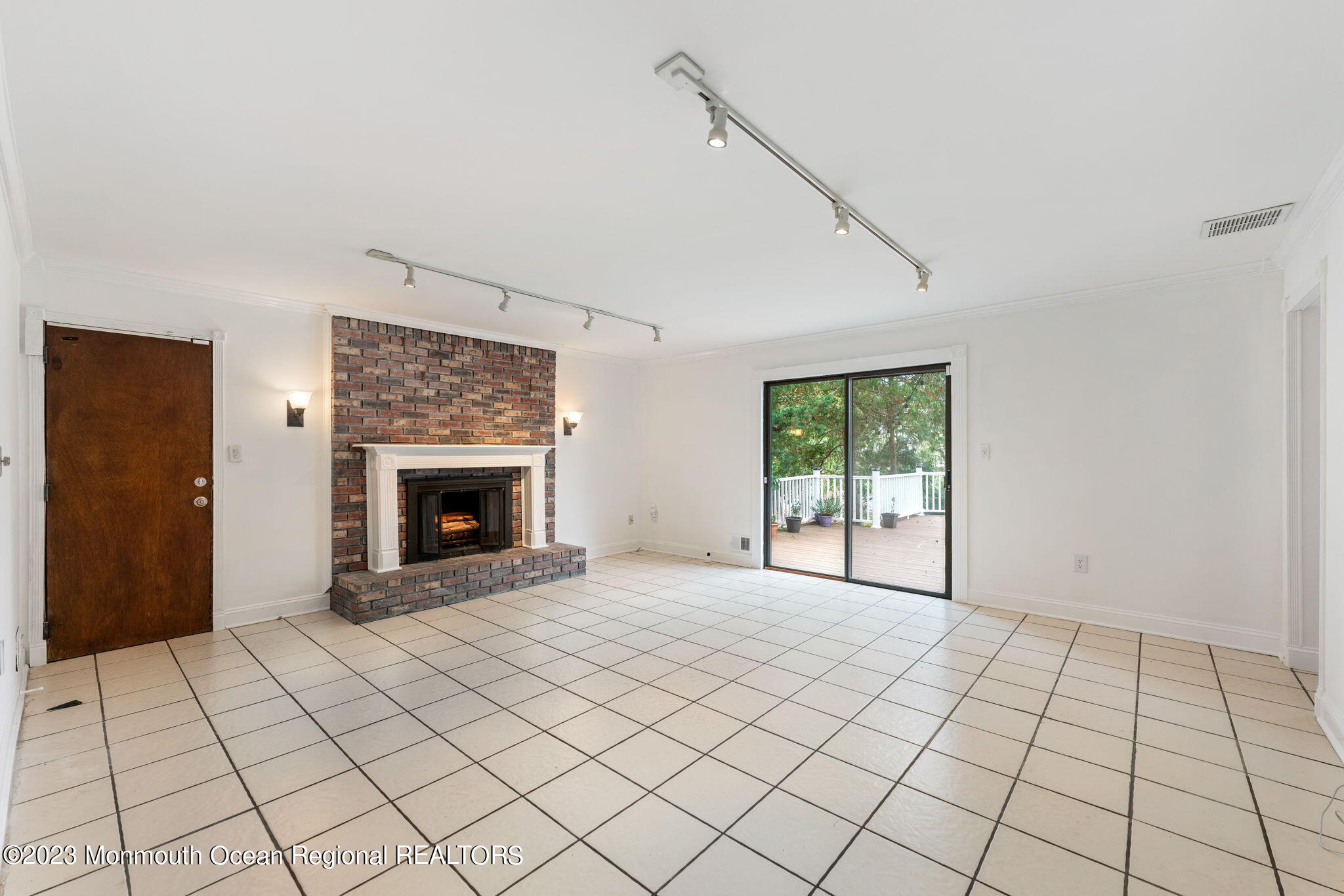 35 Lambert Johnson Drive Asbury Park, NJ 07712 - Photo 13 of 34 a view of an empty room with a fireplace and a window