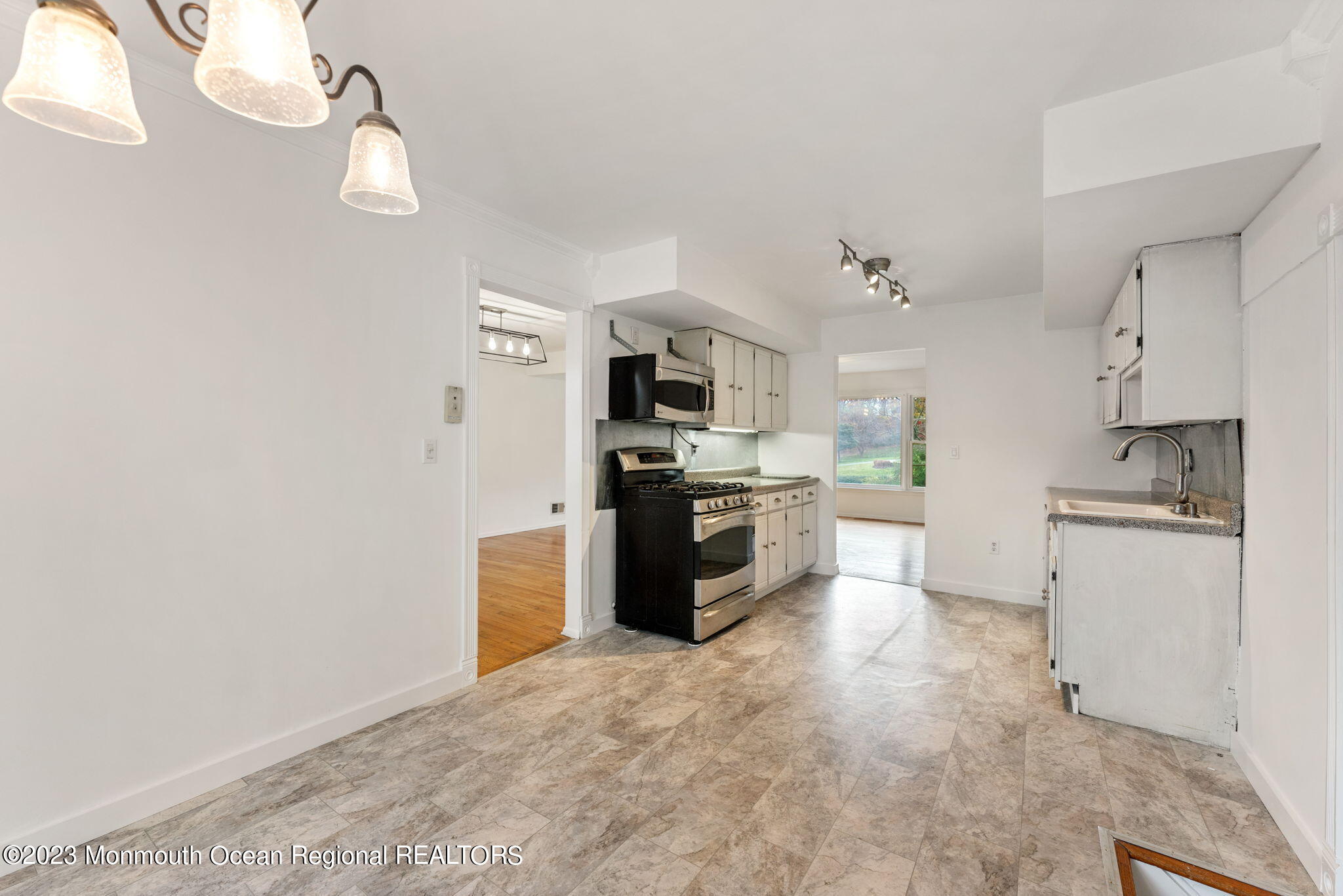 35 Lambert Johnson Drive Asbury Park, NJ 07712 - Photo 15 of 34 a kitchen with granite countertop a refrigerator stove top oven and sink