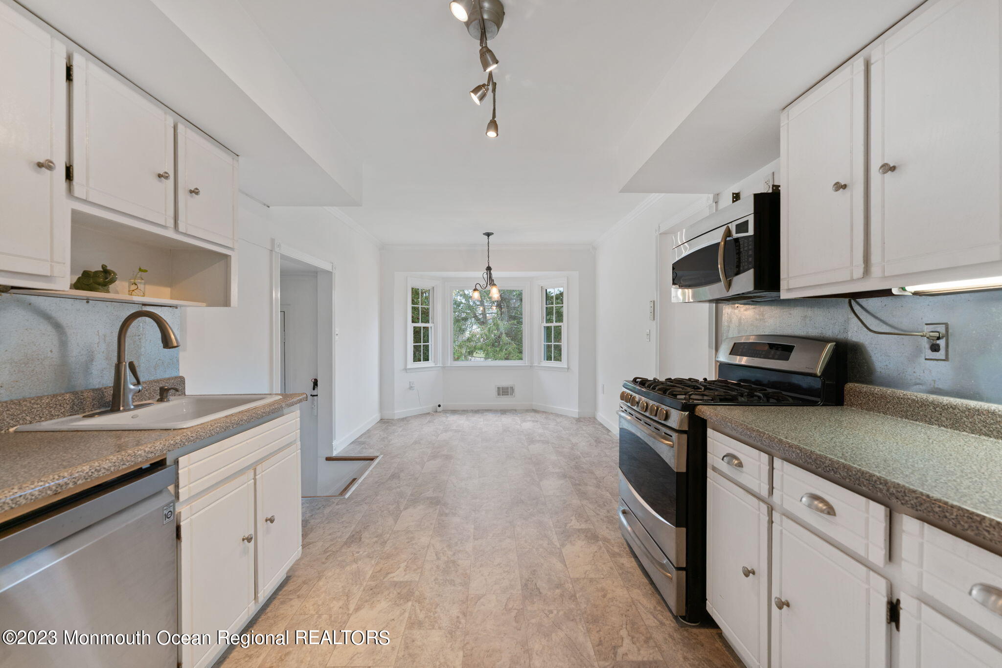 35 Lambert Johnson Drive Asbury Park, NJ 07712 - Photo 18 of 34 a kitchen with granite countertop a sink stove and cabinets