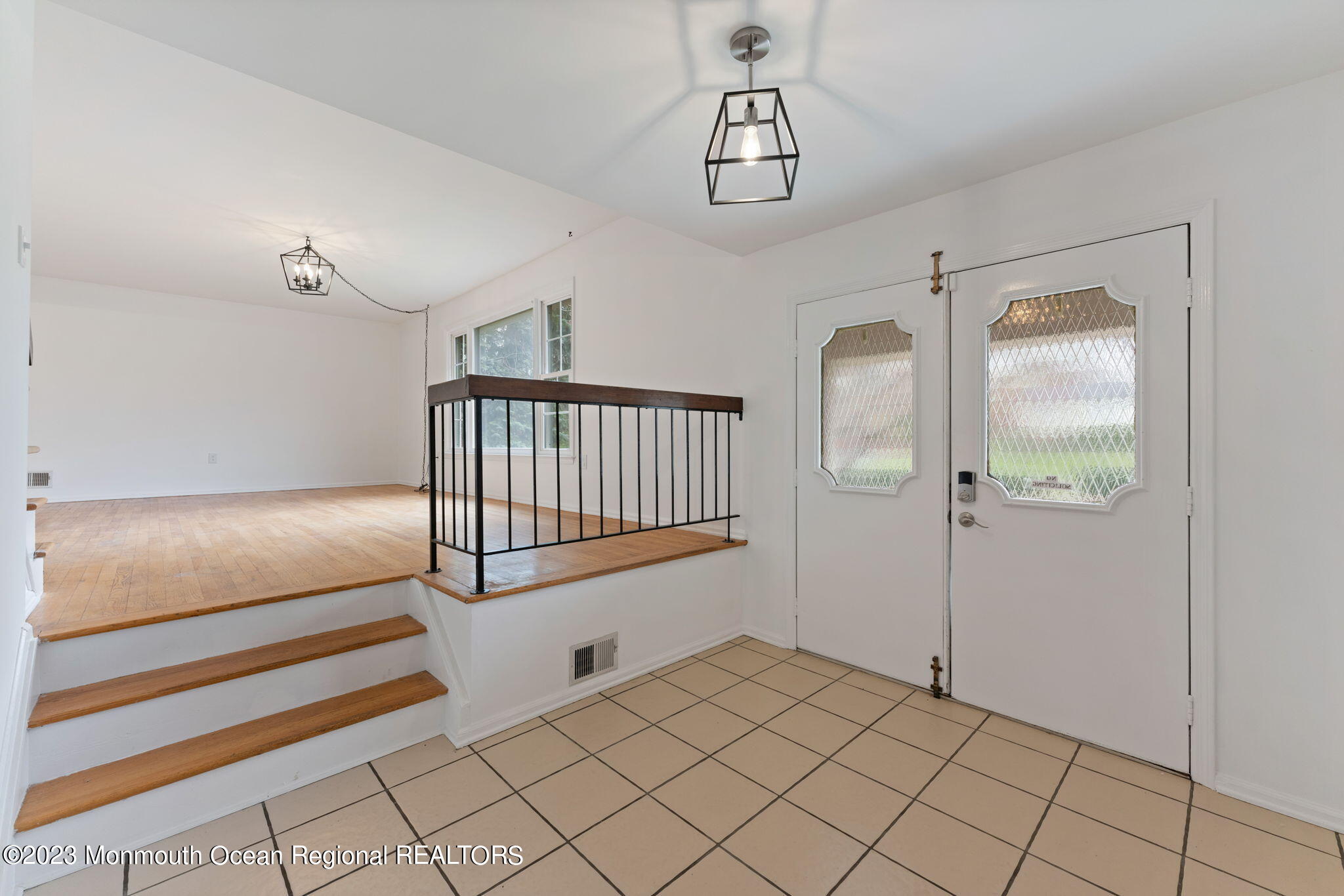 35 Lambert Johnson Drive Asbury Park, NJ 07712 - Photo 23 of 34 a view of entryway with stairs and chandelier