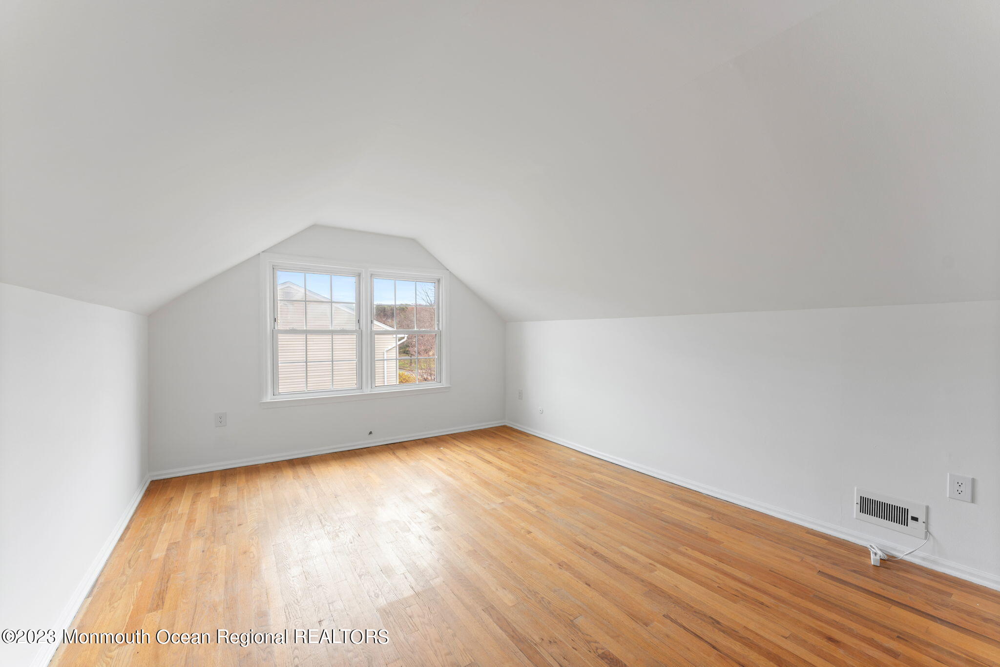 35 Lambert Johnson Drive Asbury Park, NJ 07712 - Photo 33 of 34 an empty room with wooden floor and windows
