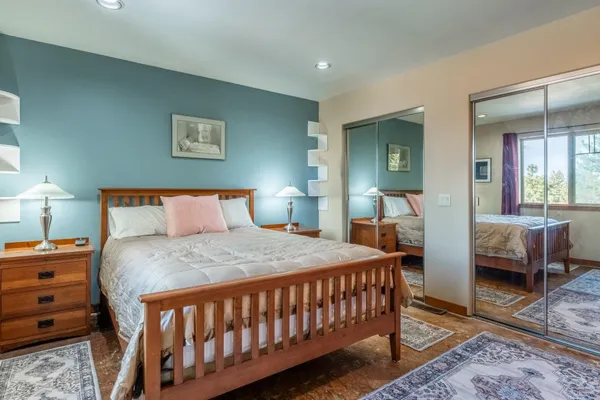 a bedroom with a bed and a dresser