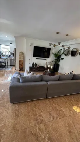 a living room with furniture and flat screen tv