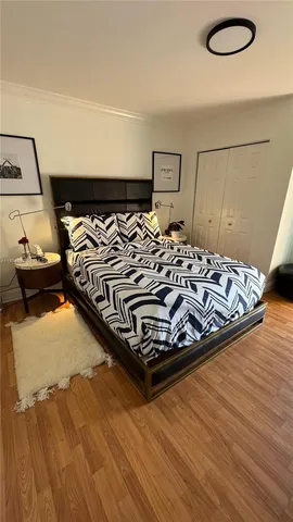 a bedroom with bed and flat screen tv