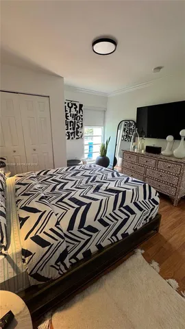 a view of a bedroom with wooden floor