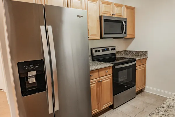 a kitchen with a refrigerator stove and microwave
